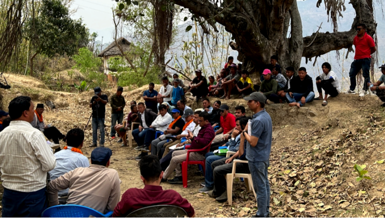 Participants express their project-related concerns during a consultation meeting held under a canopy of two big trees in Nepal. Photo credit: ADB.