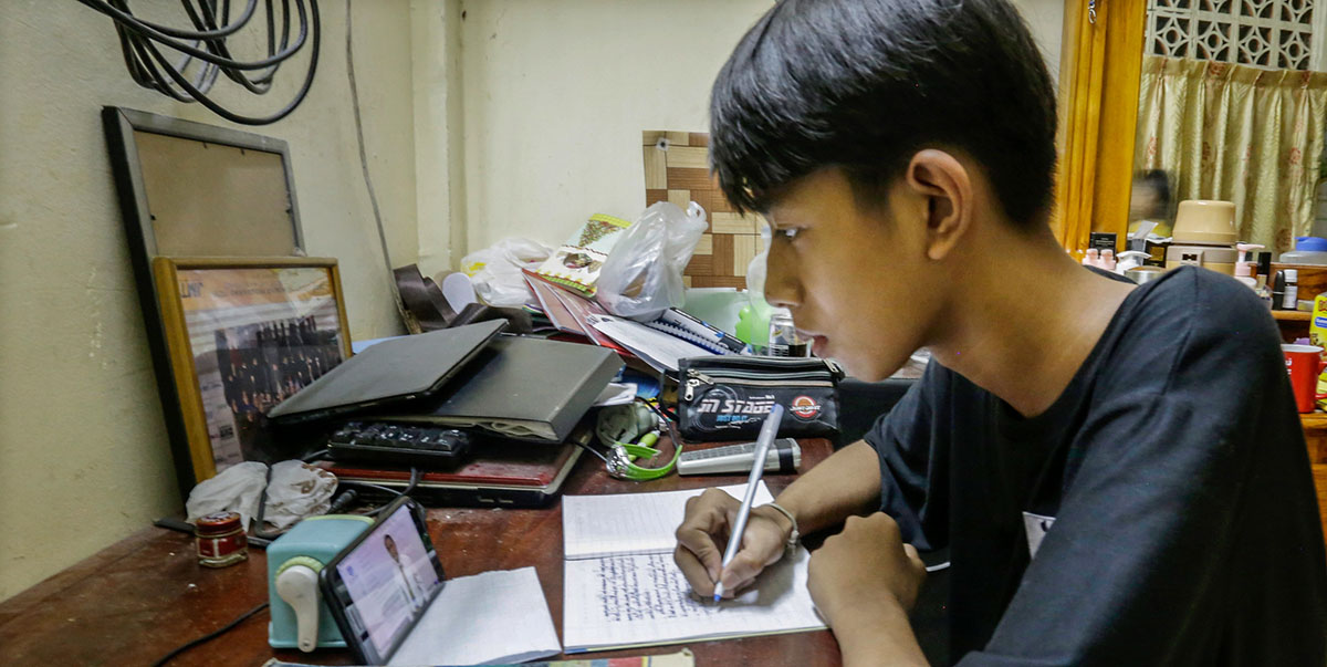 A student in Cambodia joins an online class on a mobile phone. Photo credit: ADB.