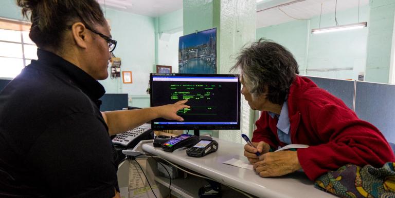 An elderly woman seeks help with her bills—highlighting the urgent need and opportunity to empower older adults through accessible digital tools and AI-driven support systems. Photo credit: ADB.
