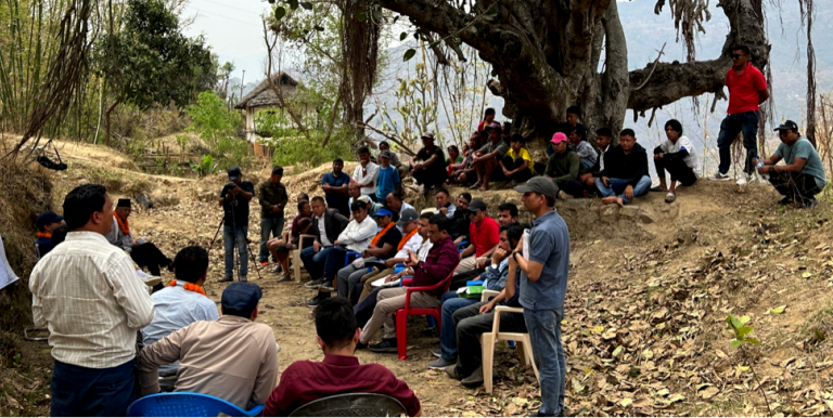 Participants express their project-related concerns during a consultation meeting held under a canopy of two big trees in Nepal. Photo credit: ADB.