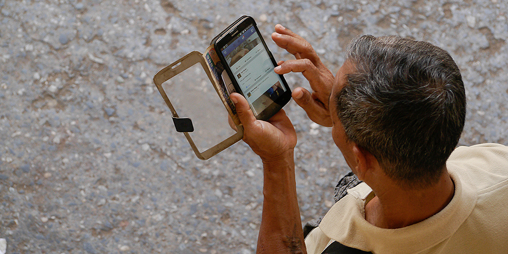 Mobile phones and the internet are two methods typically used to access one’s financial account. Photo credit: ADB.